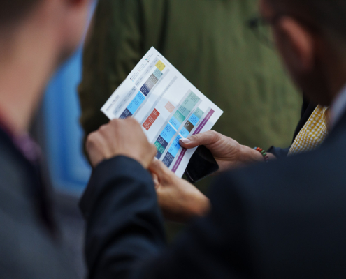 Delegates checking the printed programme