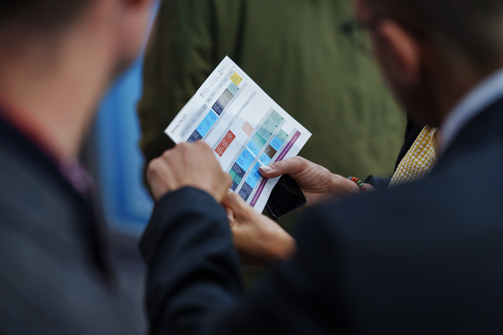 Delegates checking the printed programme